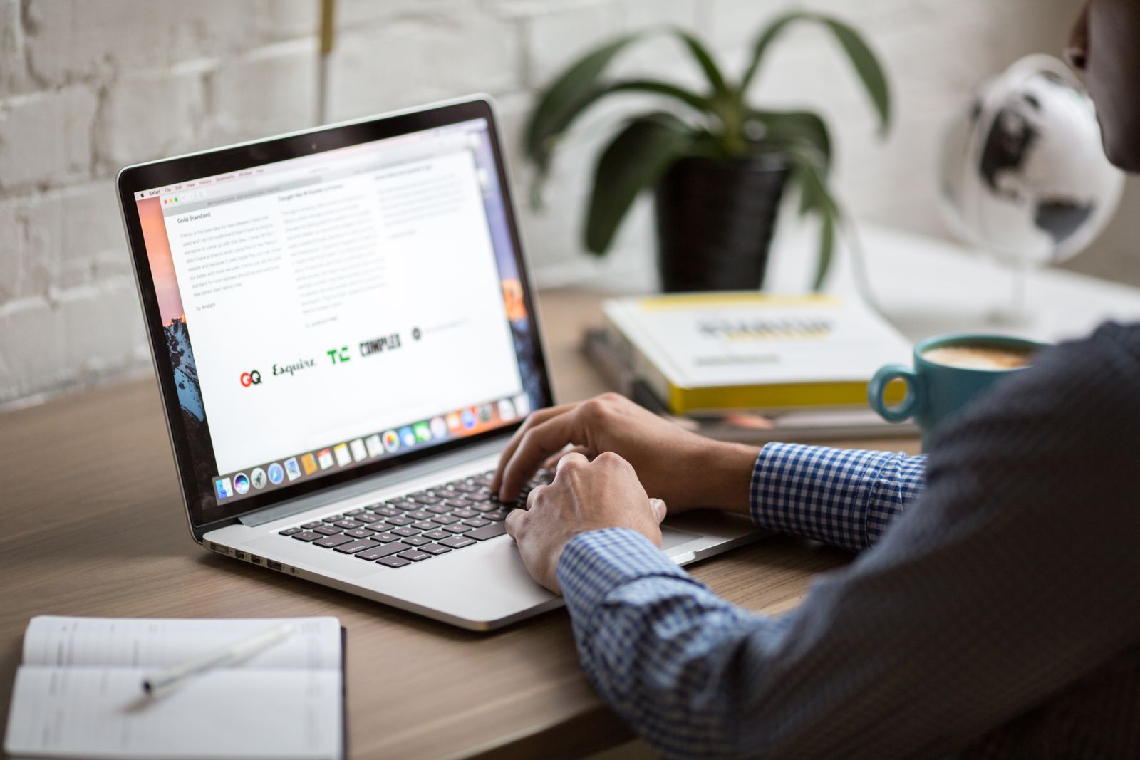 Business owner reviewing web design portfolios on a laptop in a Southern California office