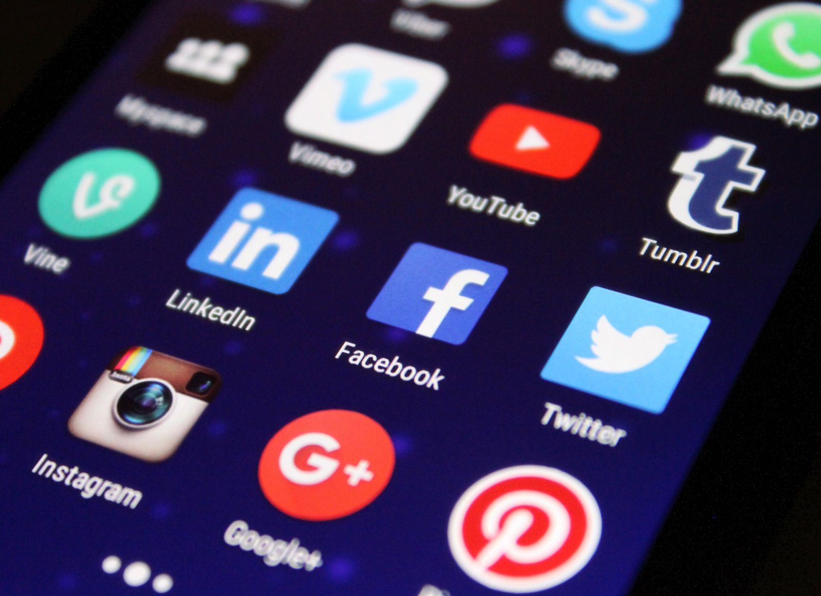 Small business owner managing social media accounts from a phone at the counter